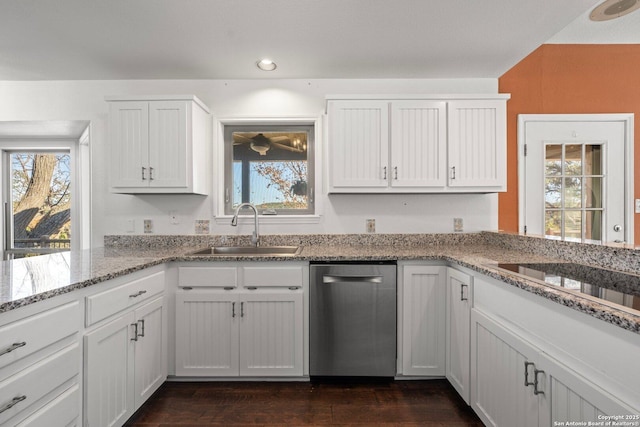 kitchen featuring white cabinets, dishwasher, sink, and light stone counters