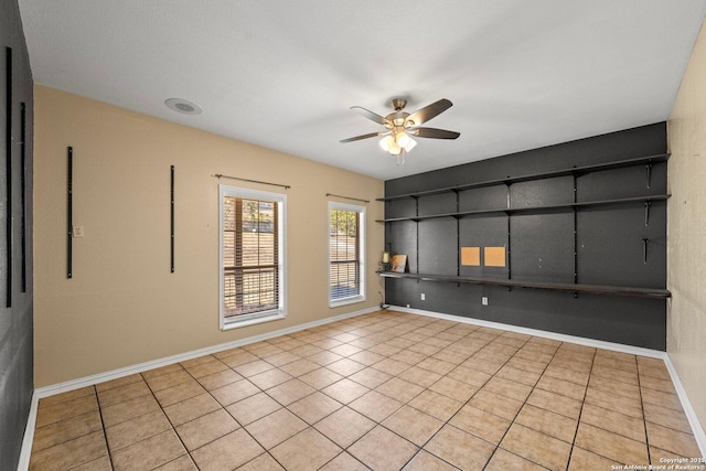 unfurnished room featuring ceiling fan and light tile patterned floors