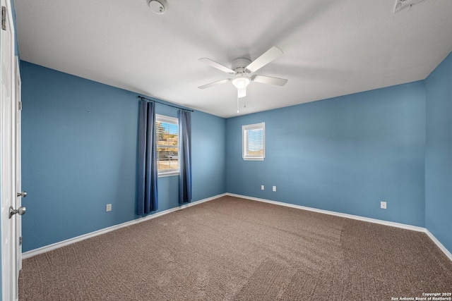 carpeted empty room with ceiling fan