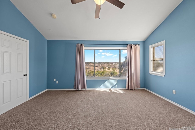 unfurnished bedroom featuring ceiling fan, carpet, and vaulted ceiling