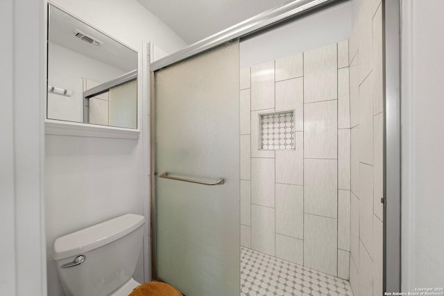 bathroom featuring toilet and walk in shower