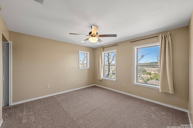 spare room featuring ceiling fan and carpet flooring