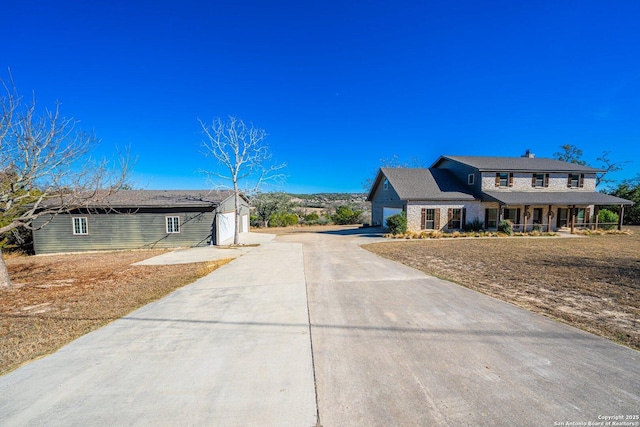 view of front of property featuring covered porch and a garage