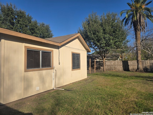 view of side of home with a yard