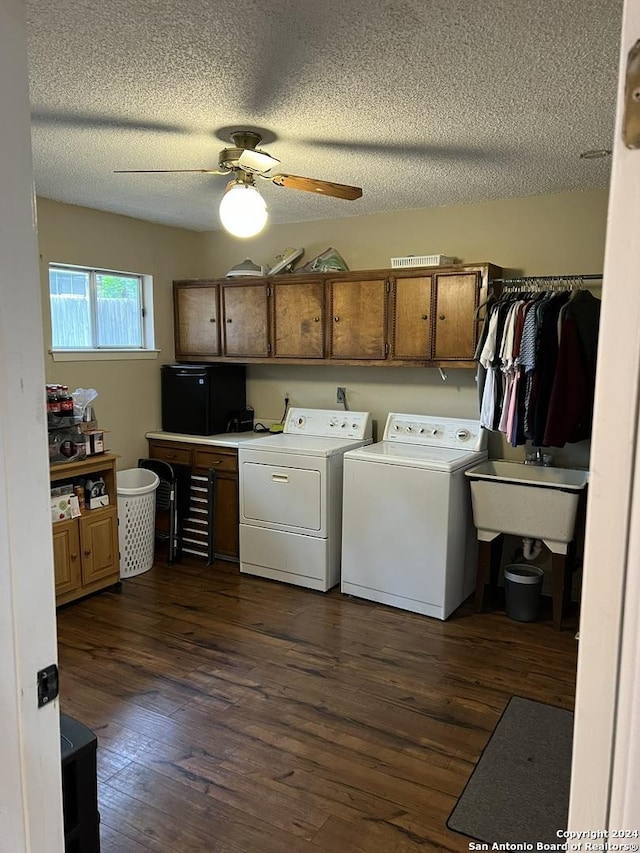 washroom with dark hardwood / wood-style floors, cabinets, washing machine and clothes dryer, and ceiling fan