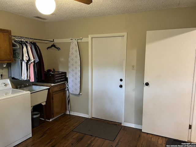 laundry room featuring a textured ceiling, washer / clothes dryer, cabinets, dark hardwood / wood-style flooring, and ceiling fan