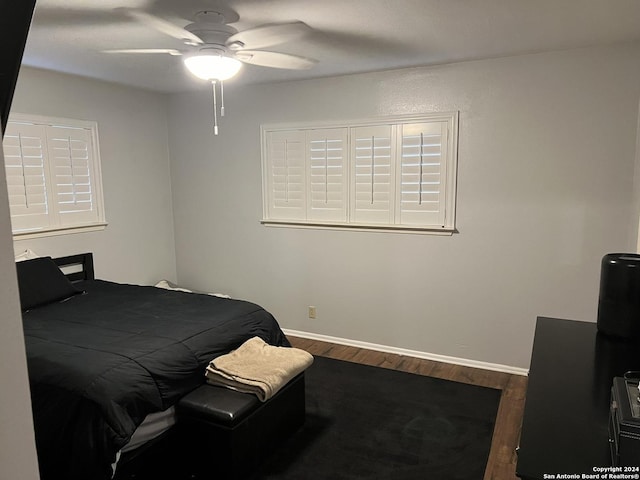 bedroom featuring ceiling fan and dark wood-type flooring