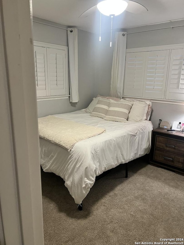 bedroom with ceiling fan and carpet