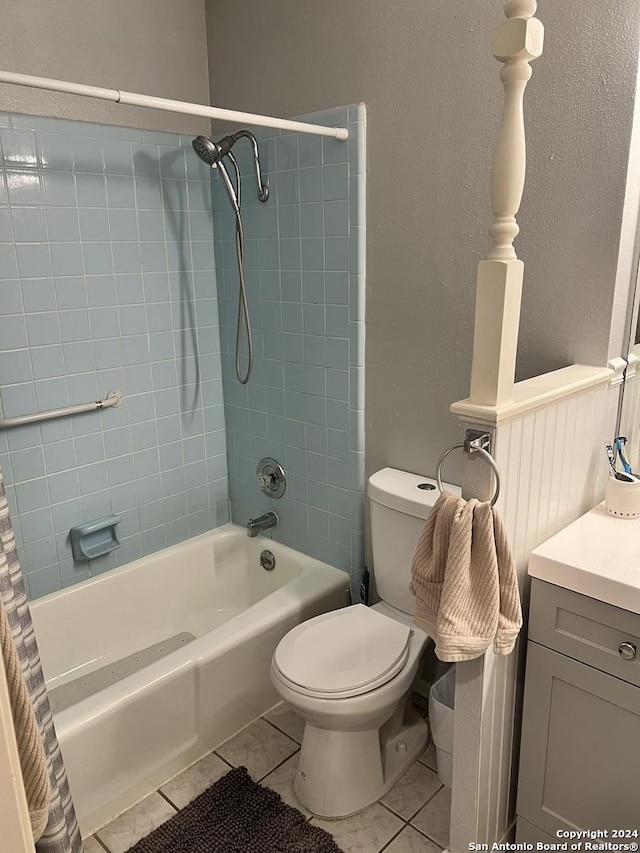 full bathroom featuring toilet, vanity, tile patterned flooring, and shower / bathtub combination with curtain