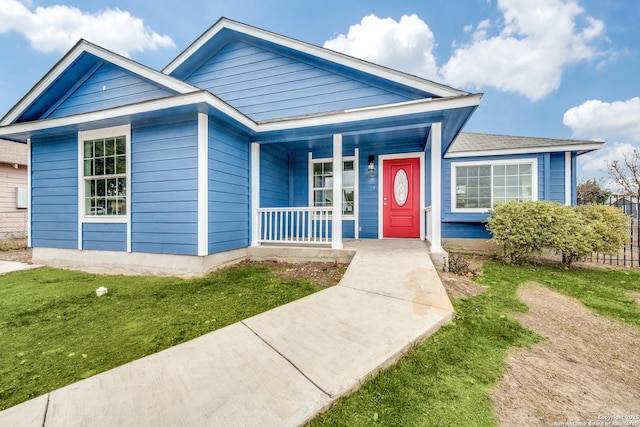 view of front of property featuring covered porch and a front yard