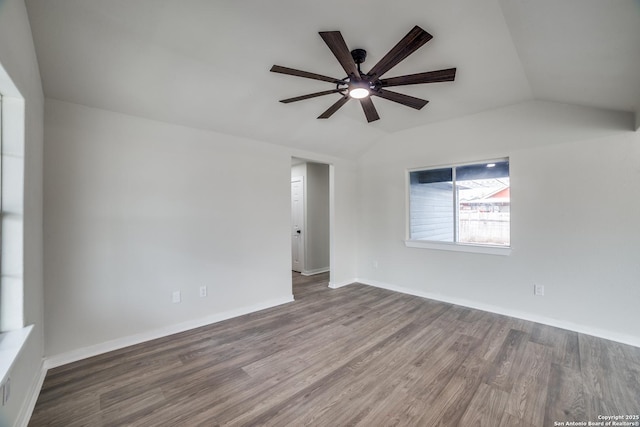 empty room with vaulted ceiling, ceiling fan, and hardwood / wood-style floors