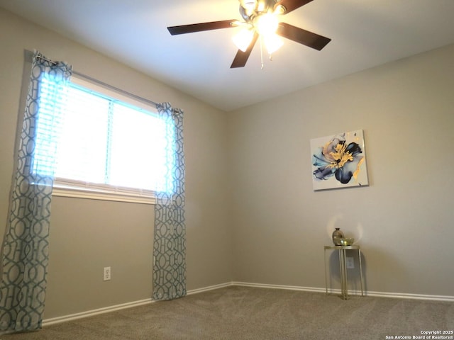 carpeted spare room with ceiling fan