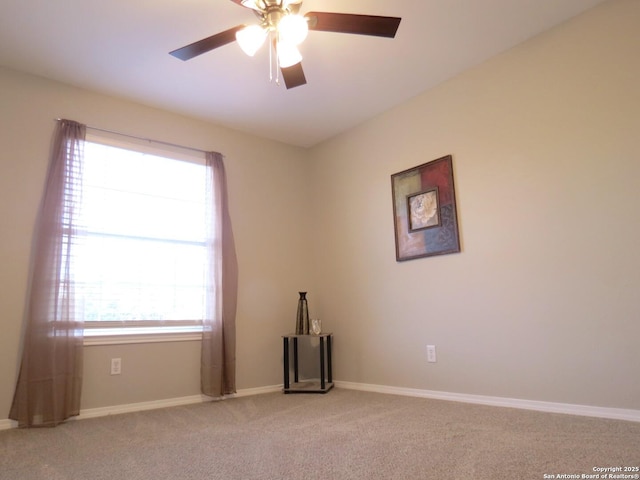 carpeted empty room featuring ceiling fan