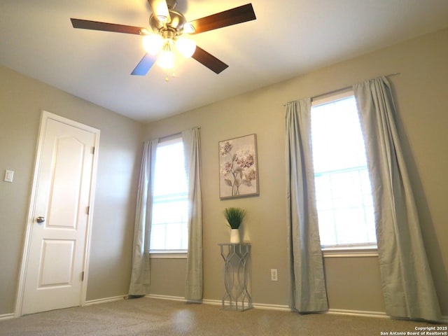 spare room featuring carpet floors and ceiling fan