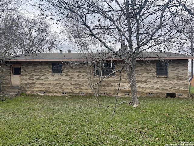 rear view of house with a yard