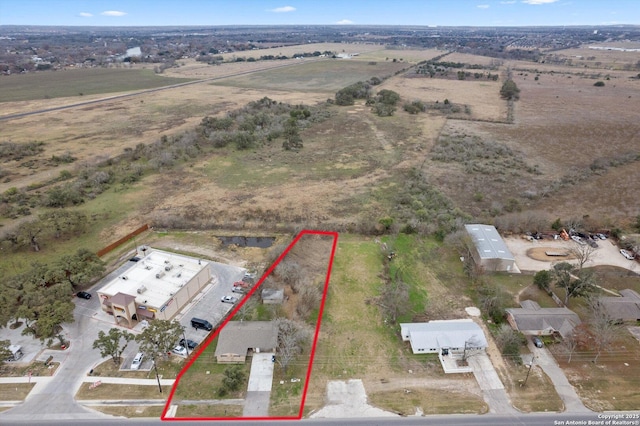 birds eye view of property featuring a rural view