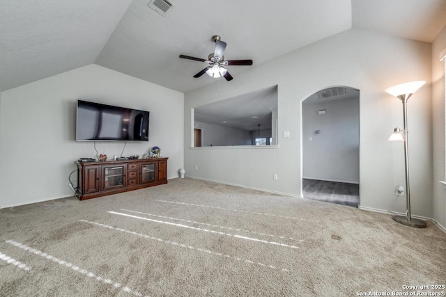 unfurnished living room featuring lofted ceiling, carpet, and ceiling fan