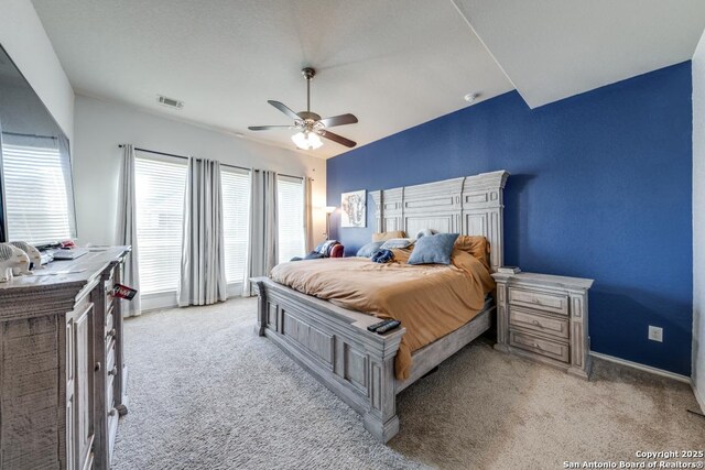 carpeted bedroom with vaulted ceiling and ceiling fan