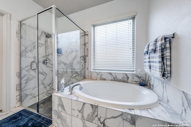 bathroom featuring separate shower and tub