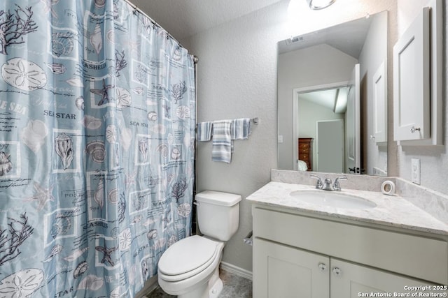 bathroom featuring lofted ceiling, vanity, toilet, and curtained shower