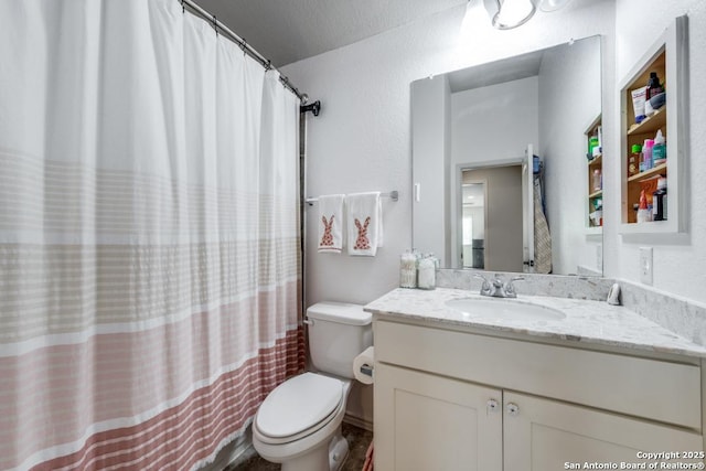 bathroom with vanity, a textured ceiling, and toilet