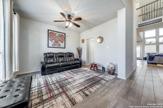 living room featuring ceiling fan and wood-type flooring