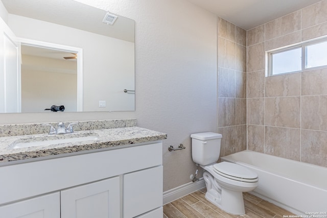 full bathroom featuring toilet, vanity, and  shower combination