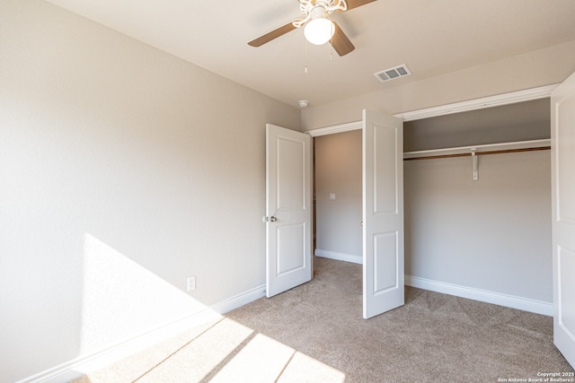 unfurnished bedroom featuring ceiling fan, a closet, and light colored carpet