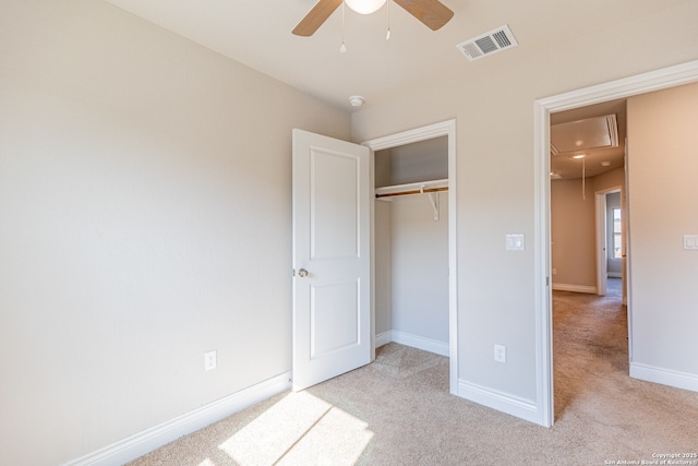 unfurnished bedroom with ceiling fan, a closet, and light colored carpet