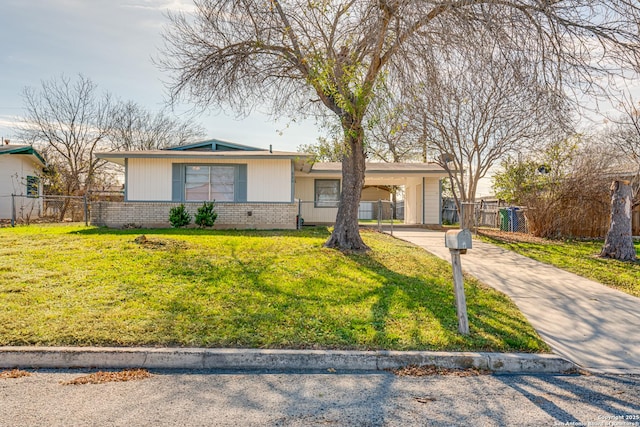 ranch-style house featuring a front yard and a carport