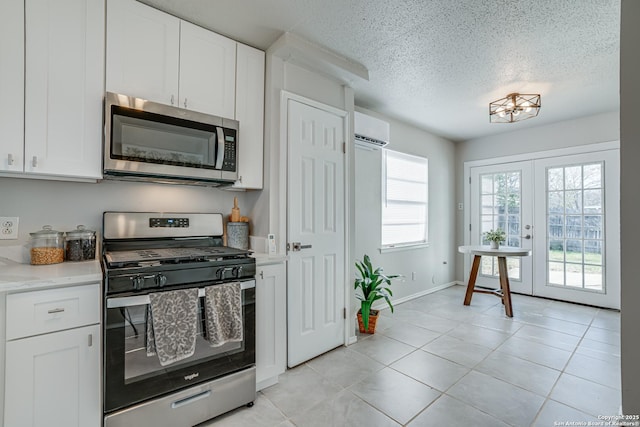 kitchen featuring white cabinets, stainless steel appliances, and french doors