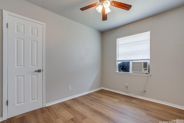 empty room featuring light wood-type flooring, ceiling fan, and a textured ceiling