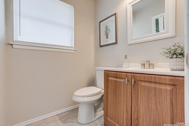 bathroom featuring toilet, vanity, and tile patterned floors