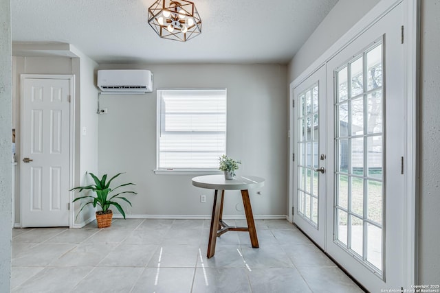 entryway featuring an inviting chandelier, light tile patterned floors, a wall mounted air conditioner, french doors, and a textured ceiling