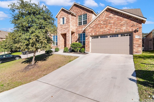 view of front of home with a garage and a front lawn