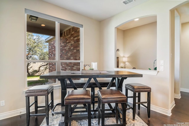 dining space with dark hardwood / wood-style floors