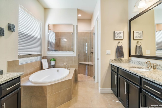 bathroom with tile patterned flooring, shower with separate bathtub, and vanity