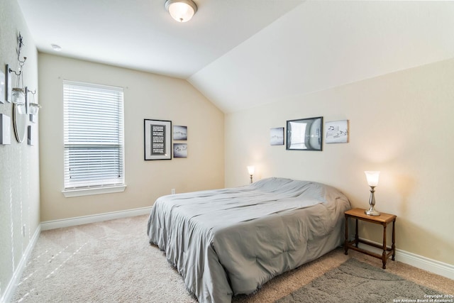 carpeted bedroom with vaulted ceiling