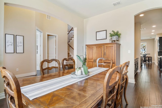 dining space featuring dark wood-type flooring