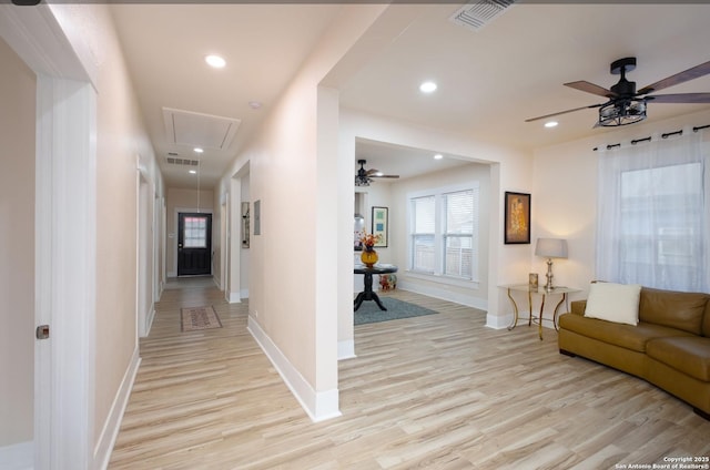 corridor with light hardwood / wood-style floors