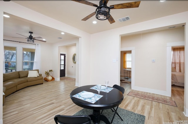 living room featuring ceiling fan and light wood-type flooring