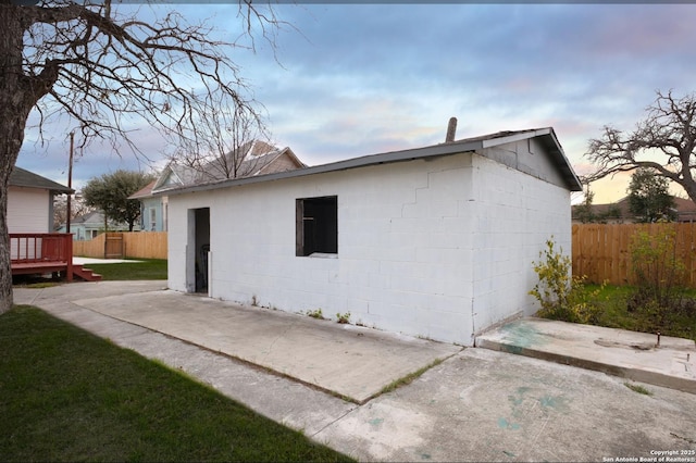 property exterior at dusk with a patio area