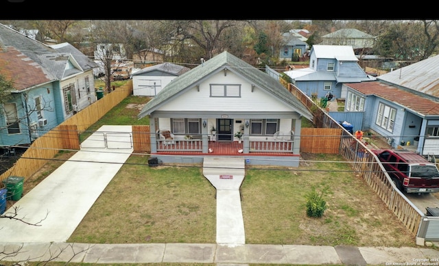 bungalow featuring a front lawn and a porch