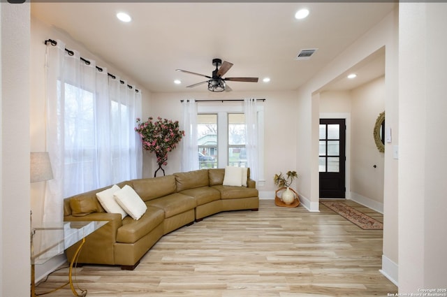 living room featuring ceiling fan and light hardwood / wood-style floors