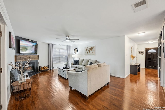 living room with ceiling fan and dark hardwood / wood-style floors