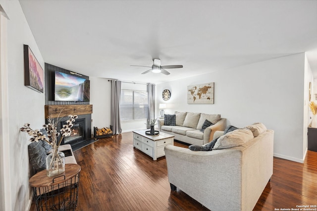 living room featuring ceiling fan and dark hardwood / wood-style flooring