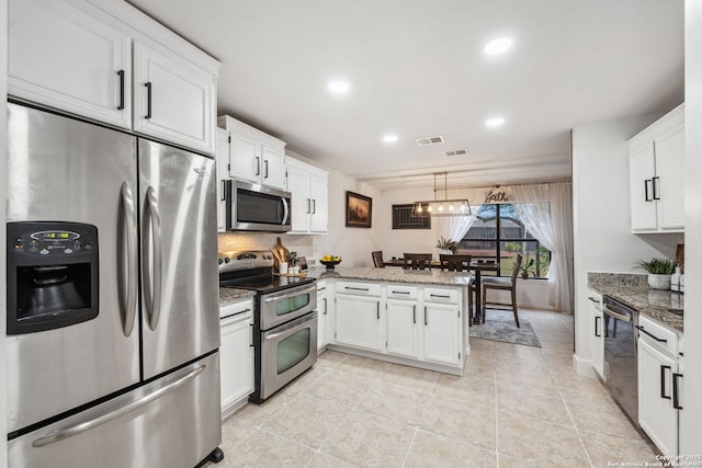 kitchen with decorative light fixtures, kitchen peninsula, light stone countertops, stainless steel appliances, and white cabinets