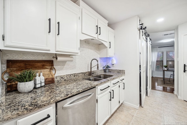 kitchen featuring white cabinetry, dishwasher, light stone counters, and sink