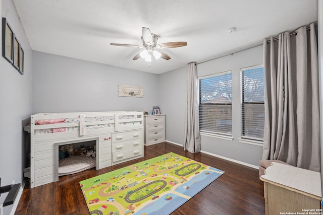 bedroom with ceiling fan and dark hardwood / wood-style floors