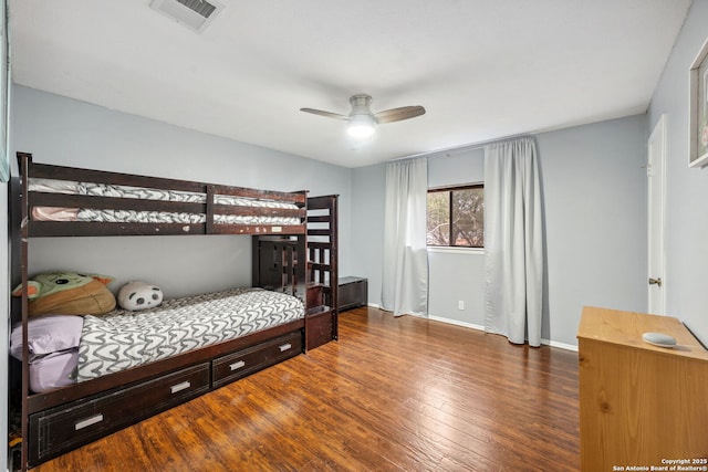 bedroom with ceiling fan and dark hardwood / wood-style floors